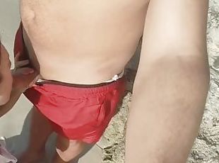 I suck on a public beach and a stranger cums on my tits.