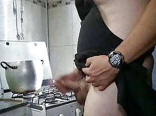 Sexy man at the kitchen cooking nude.
