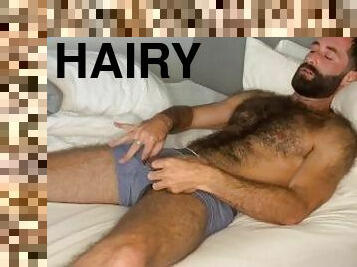 Hairy guy jerks off in hotel room