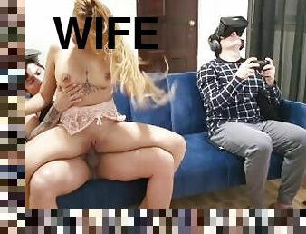 Wife cheats on her cuckold husband while playing video games. His best friend fucks her on the couch