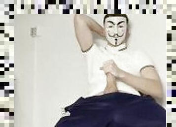 Twink wearing anonymous mask wanks on camera