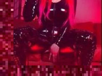 Pink haired Luvie Doll smoking EVE 120s cigarette in a PVC catsuit looking like the devil with nails