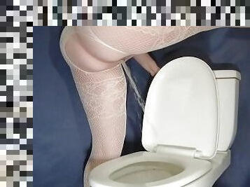 Sexy peeing standing on toilet