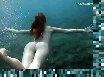 Skinny dipping redhead filmed underwater