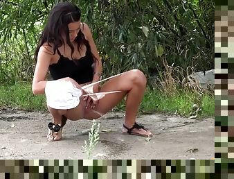 Cute brunette takes a hot piss outdoors