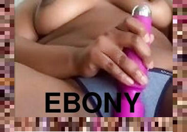 Ebony with nipple ring has fun with vibrator