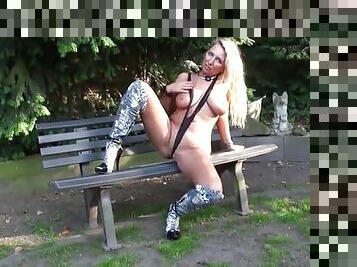 Cougar fucks herself in the park sitting on a bench with a vibrator