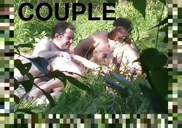 Naturist couple caught fucking in grass