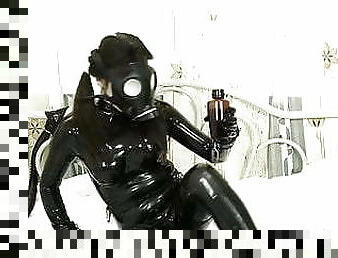 Cute girl in latex masturbates with vibrator and mask