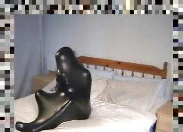 Cute girl in black latex catsuit with mask makes self bondage in rubber vacuum sleepbag - part 2