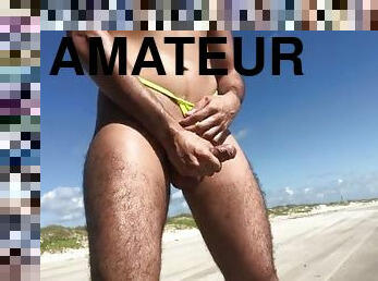 Masturbating on the beach in a thong while vehicles pass by