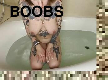 naked tattoed baby in jacuzzi