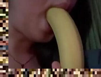 At home watching tv while im sucking a banana