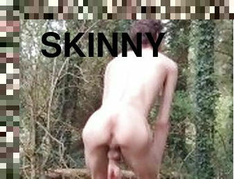 Very skinny lad strips outside in the woods in nature and shows off his body while touching himself
