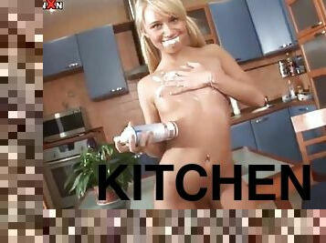 Blonde teen masturbates in the kitchen with a big dildo