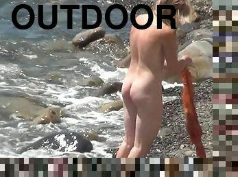 Awesome blonde is getting naked outdoors