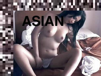 Pretty asian girl plays with her tits and pussy.