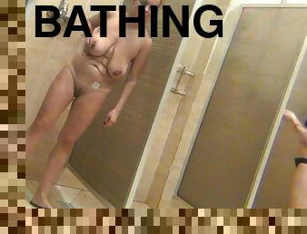 Hot leggy babe is washing her boobies
