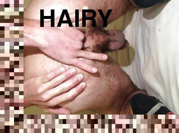The bottom of a boy playing with a hairy ass