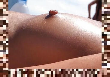 Naked tits and nipples on ladies at the beach