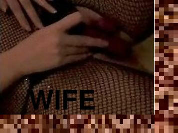 Sexy hot young wife in fishnet bodysuit teasing with vibrator