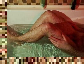 Man washes another guy's feet and ass in the bath, fingering, handjob. POV video
