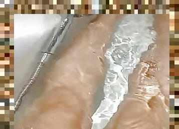 Sexy hot girl leg playing on bath tab.