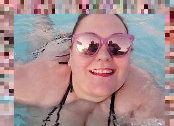 BBW bouncing in the pool in a string bikini