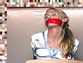 Nurse in bondage with taped mouth