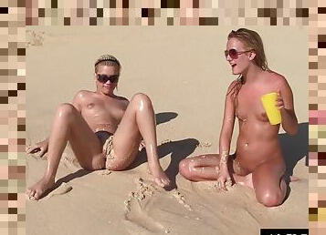 Six horny lesbians do it on a public beach