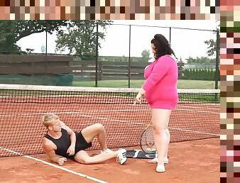 Obese woman facesits on her trainer at the tennis court