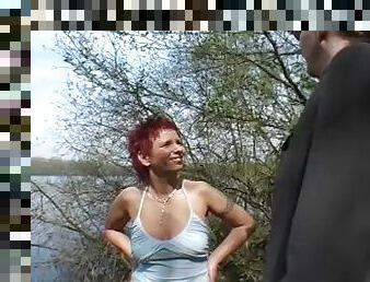 Redhead german lady gets her mouth stuffed by the lake