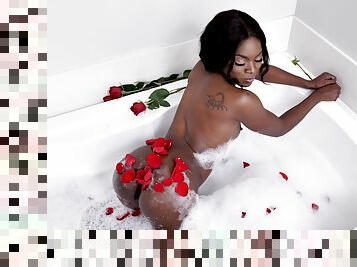 Ebony beauty reveals her curvy ass and tits in seductive tub scenes