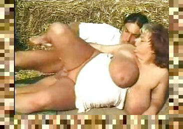 He sucks on her BBW tits outdoors