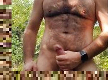 Hot hairy dude strips and jerks his big uncut dick in the woods