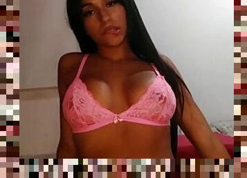 Latina in pink lingerie takes off her clothes